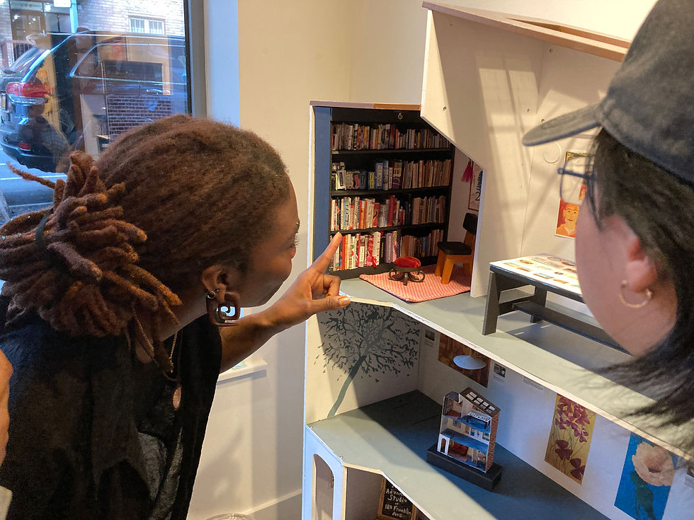 Lilo and Estella look at the dollhouse