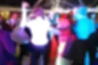 Lively wedding guests dancing to a wedding DJ