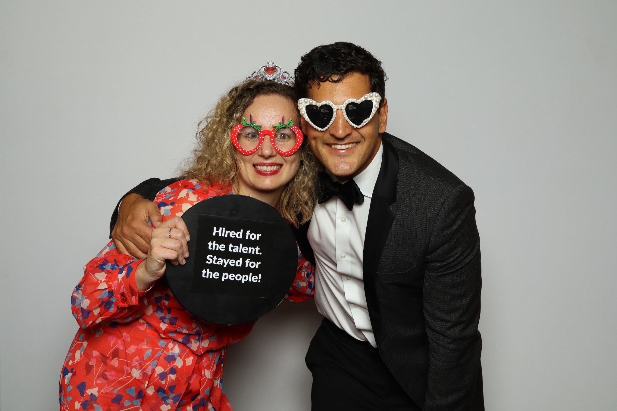 Two guests enjoying a Simple Snaps corporate photo booth with a custom event prop