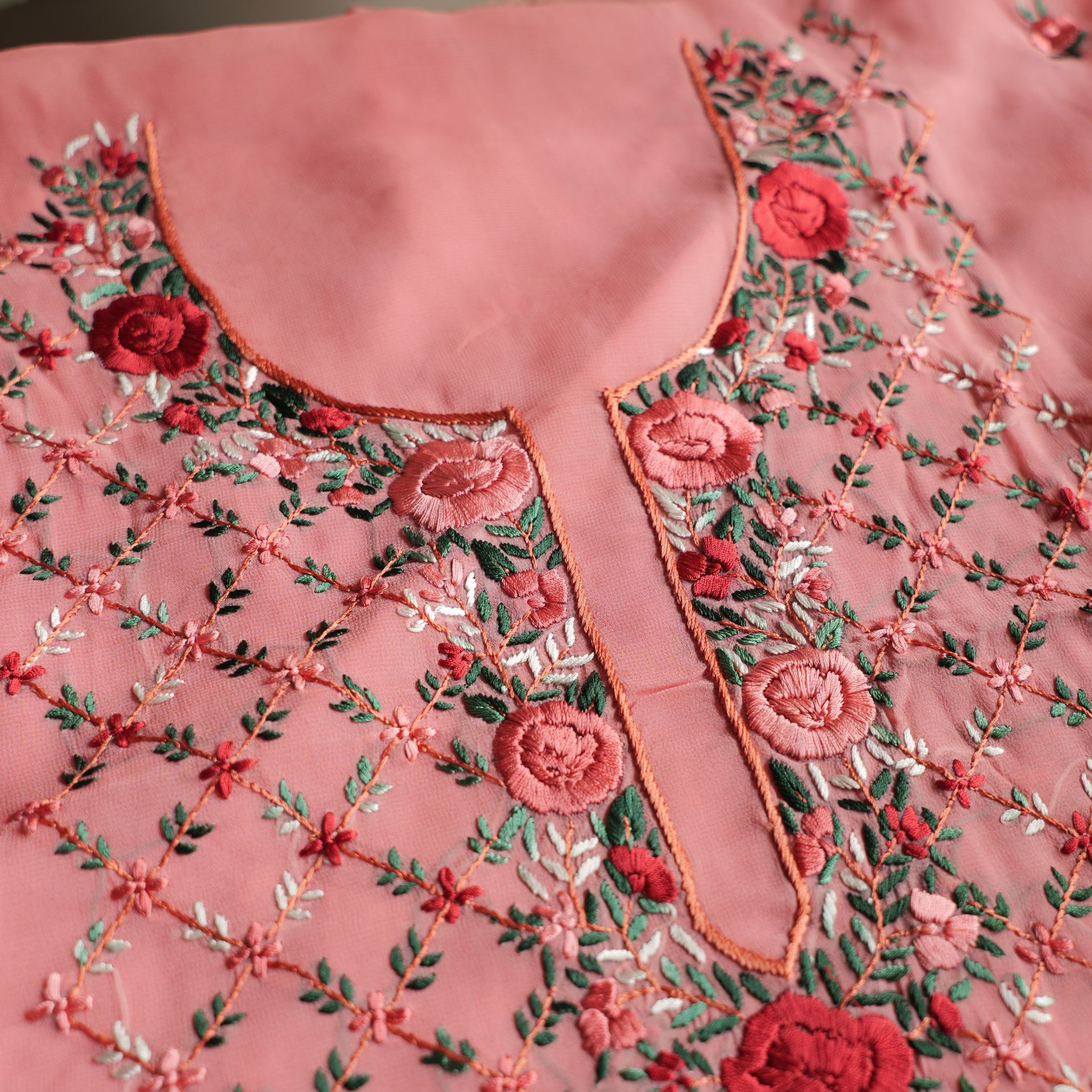 Full-length view of old rose Parsi kurta with flower motifs adorning the entire fabric, perfect for festive occasions