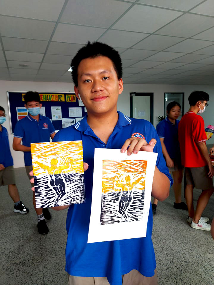A proud student with their art