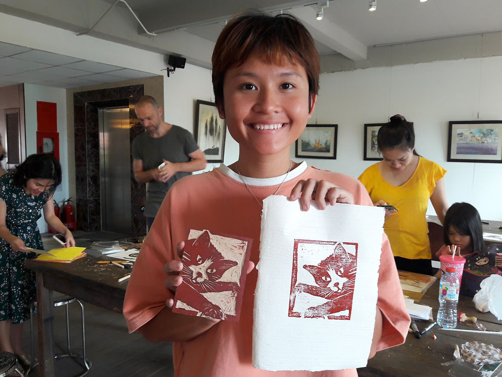 Customer at Thao Dien Art Space woodcut workshop run by Jack Clayton holding their woodcut, D2 HCMC