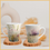 Thumbnail: Left and right view of a 12oz ceramic coffee mugs with colorful botanical floral design