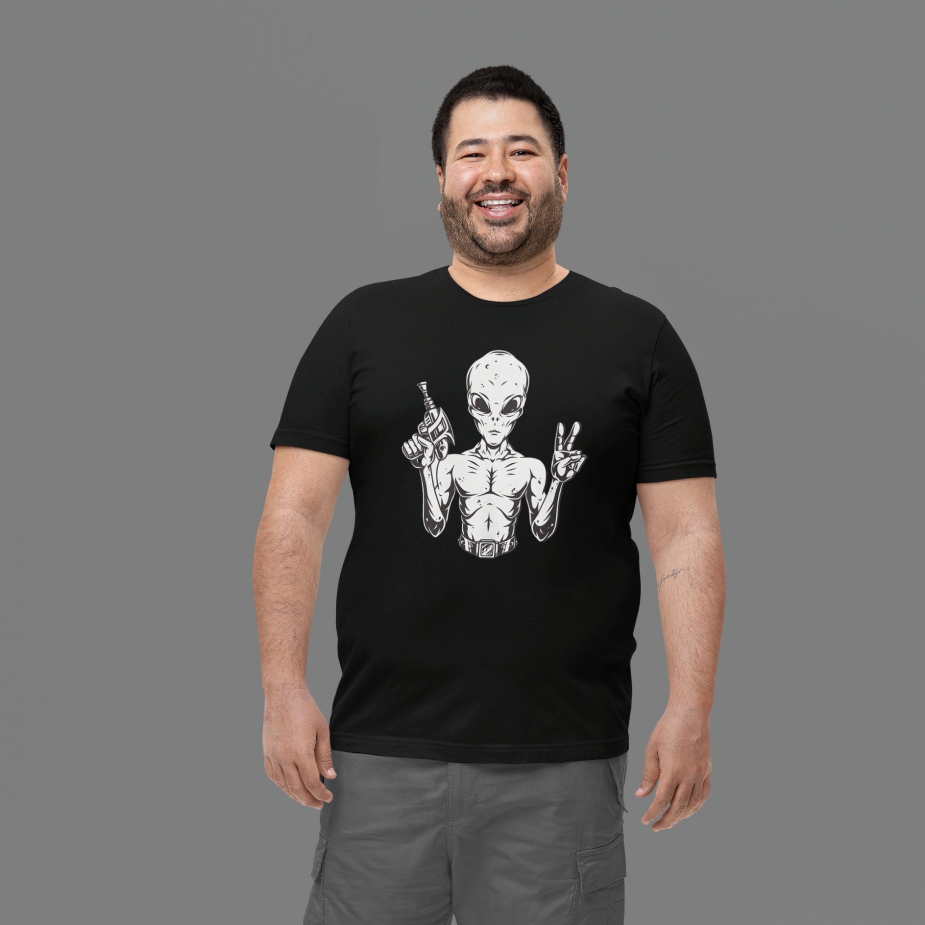 Man wearing a black tee with a Alien with ray gun and peace sign illustration