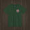 Thumbnail: Front view of a forest green Vintage Sprite Icon T-Shirt with a custom red, white, and black emblem on the top left chest.