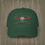 Thumbnail: A green colored Retro Canadian Lacrosse baseball cap with crossed sticks, maple leaf mask, and vintage design