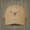 Thumbnail: A beige colored Retro Canadian Lacrosse baseball cap with crossed sticks, maple leaf mask, and vintage design