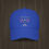 Thumbnail: Royal blue low-profile baseball cap with 'Tennis Anyone?' in red, white, and blue text above crossed tennis rackets.
