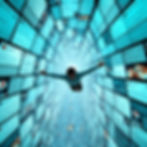 A person floats through a digital tunnel of social media posts. Blue tones dominate, creating a sense of movement and immersion.