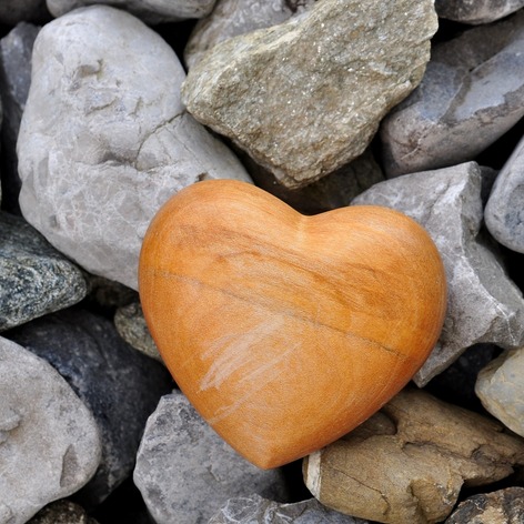 orange heart stone on bed of grey rocks