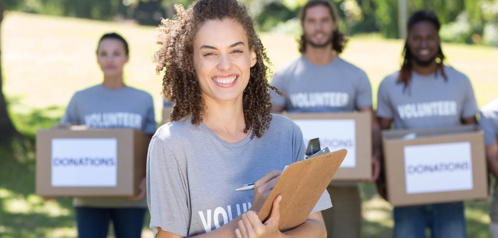 Happy volunteers in the park on a sunny day