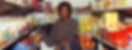 smiling-black-woman-choosing-goods-in-grocery-store-4177710