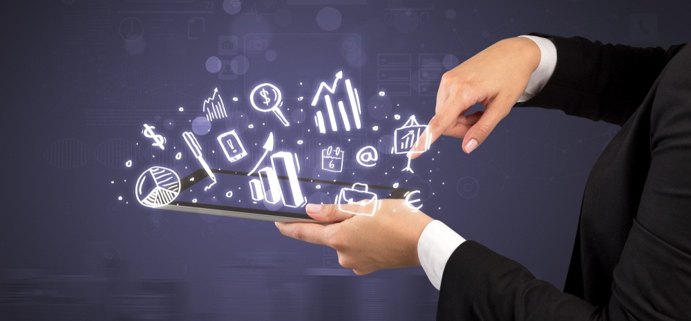 Elegant hand holding tablet with chalk drawn social media symbols above