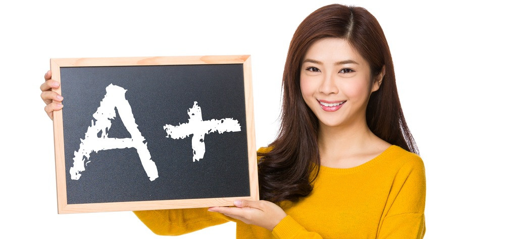 Young woman hand hold with the blackboard showing A plus mark
