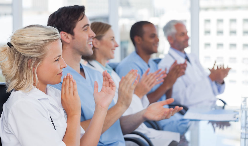 Medical team clapping hands during a conference