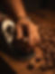 Close-up of a craftsman’s hand using a Veritas hand plane on a dark wood surface, surrounded by curled wood shavings in warm, cinematic lighting.