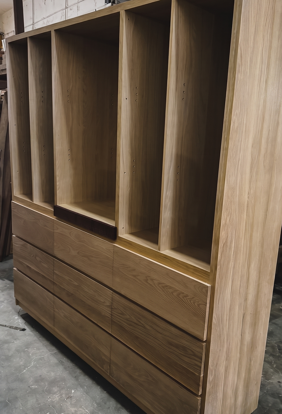 A commissioned solid white oak cabinet standing complete in the WD Custom Woodcraft workshop before delivery
