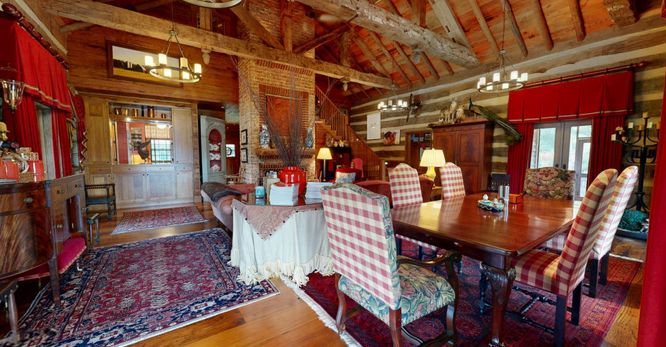 Dining room at Duvall Lodge in Easton Maryland with timber beams and chandelier.
