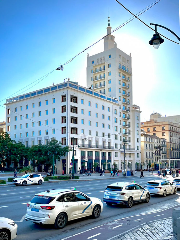 Equitativa building under a blue sky with the sun behind it