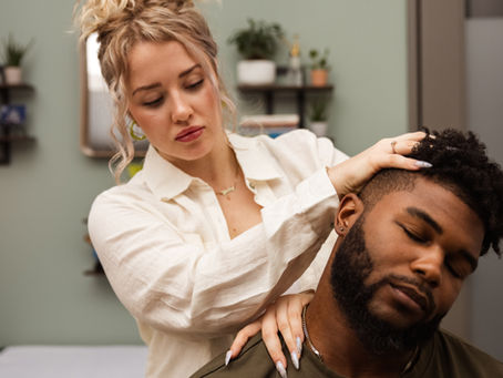 Eye-level view of a chiropractor adjusting a patient's neck in a calm treatment room