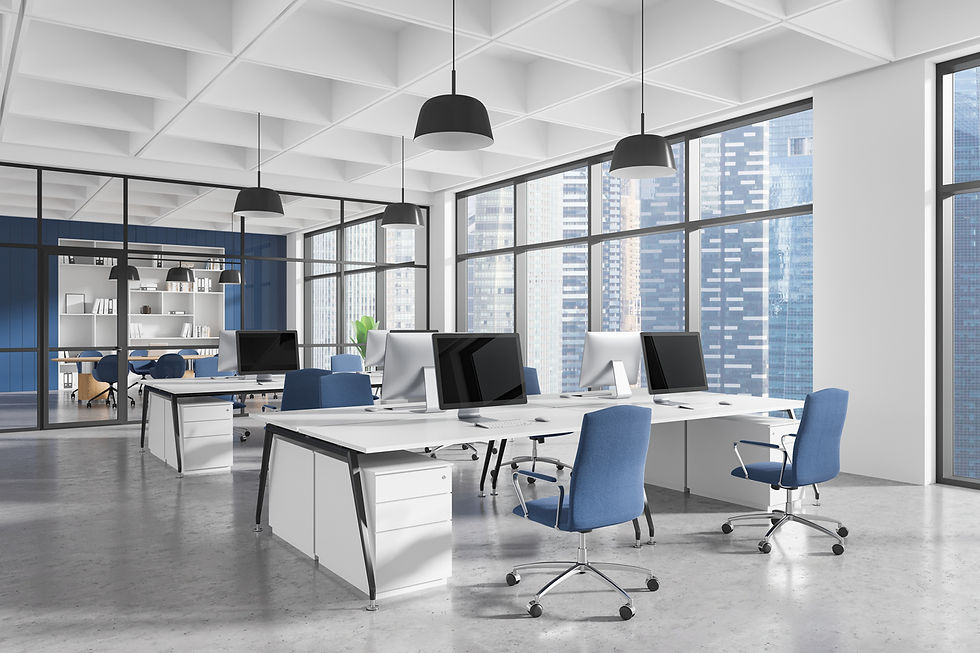 Modern office with white desks, blue chairs, and computers. Large windows show cityscape. Minimalist decor with dynamic and open feel.