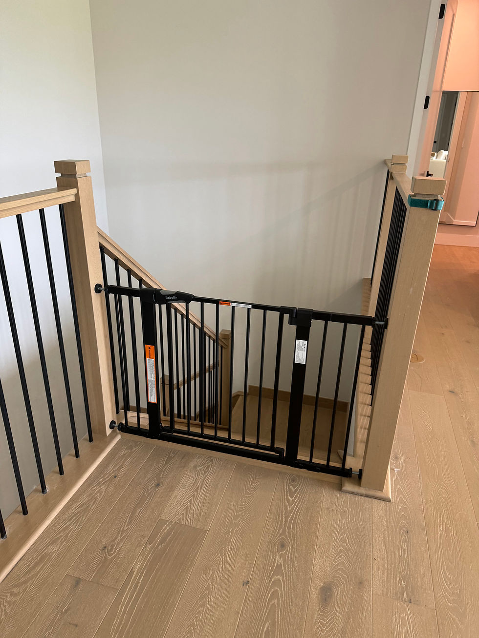 Before: Pressure mounted gate installed at the top of stairs