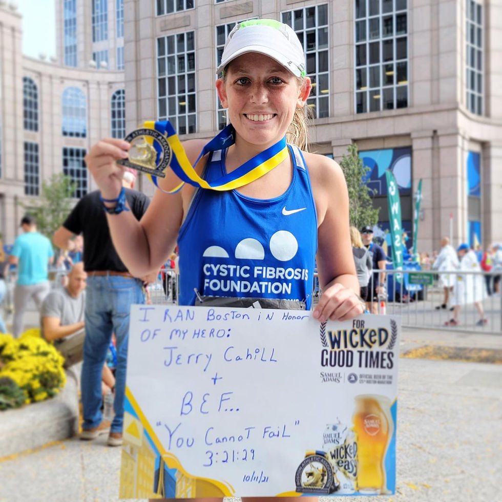 Katie O'Grady at the Boston Marathon finish wearing cystic fibrosis foundation