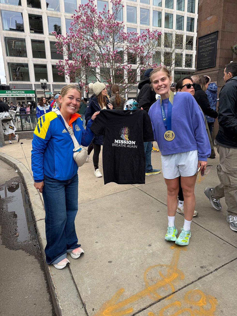 Katie O'Grady with her friend after marathon showing off Mission Breathe Again shirt