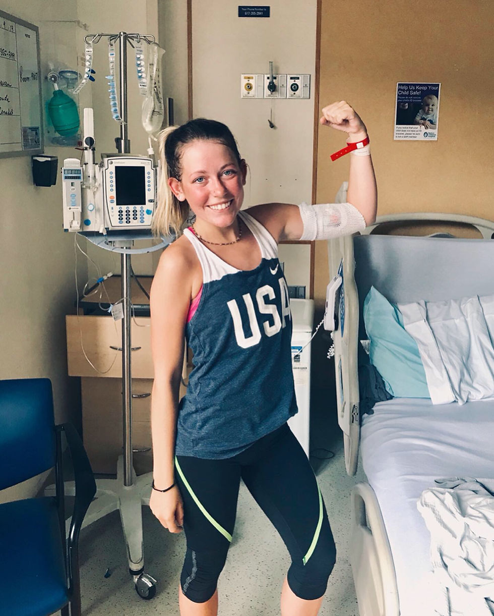 Katie O'Grady flexing bicep while in hospital receiving IV antibiotics
