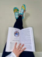 Katie holding up her legs with the CF warrior project book