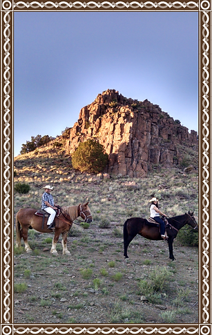 Two riders on horseback, side view
