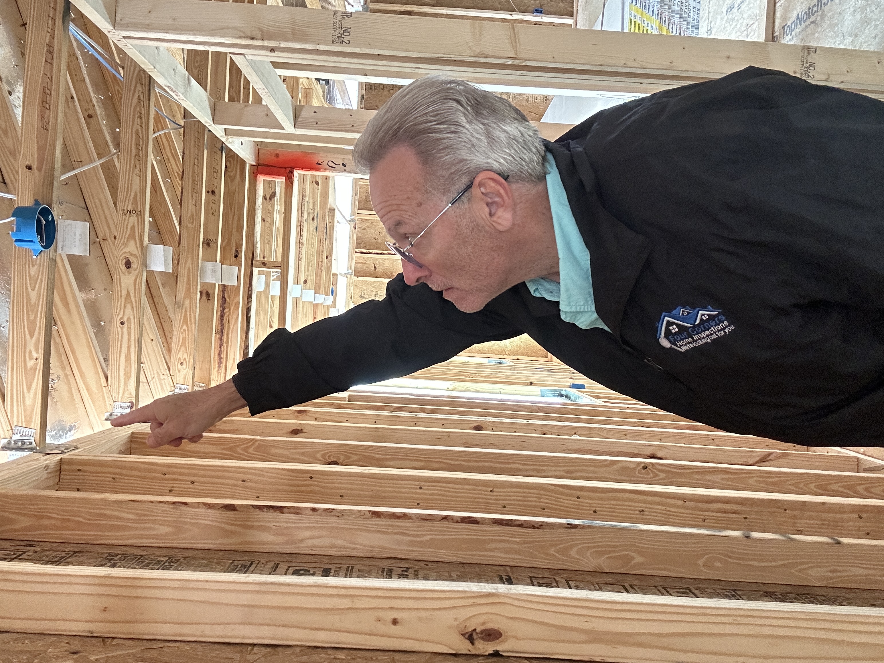 Certified Master Inspector checking framing during a pre-drywall inspection on a new South Lake County home
