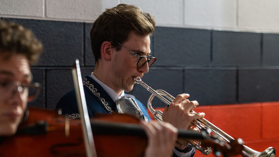 A trumpet player is warming up in the tunnels inside Daikin Park