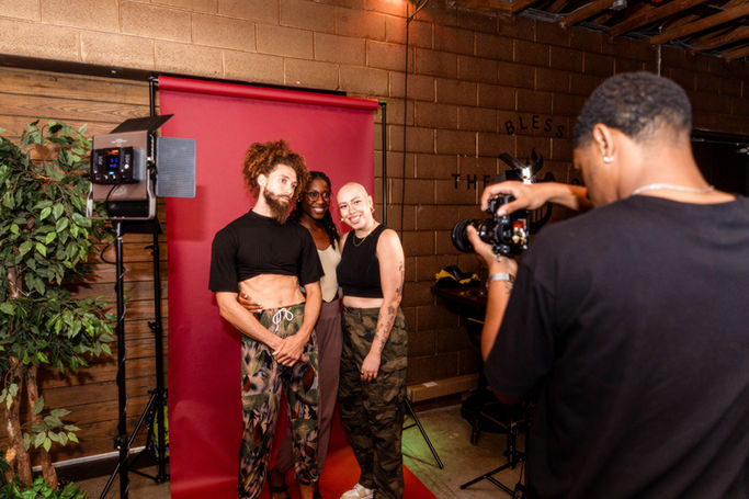 Three people in front of a photo backdrop at a DAWA event