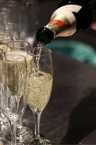 Sparkling wine being poured into glasses at the Movie Night reception