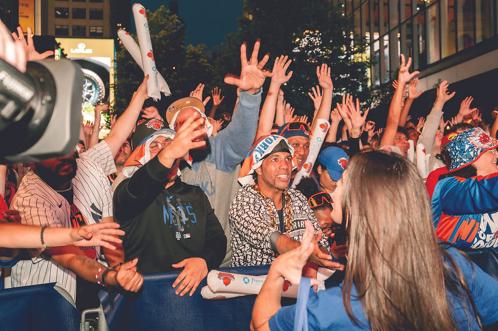 New York Knicks fans celebrate at an NBA playoff watch party outside Madison Square Garden in New York, May 17, 2025. Sports events and concerts offer more opportunities than ever to reach for free keepsakes, but several recent episodes raise a question: Is fan behavior getting worse as a result? (Ye Fan/The New York Times)