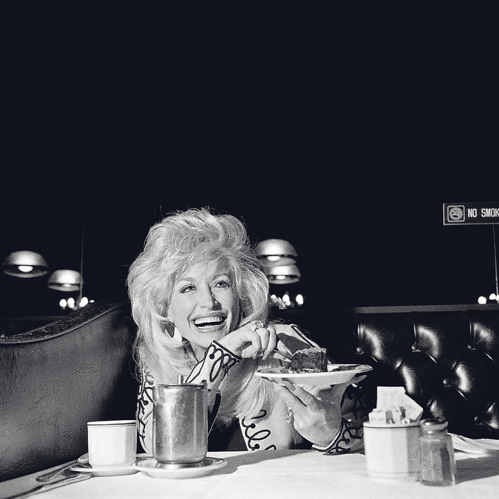 Dolly Parton, savoring a chocolate mousse cake. Parton, the country singer, songwriter, entertainer and entrepreneur whose rags-to-riches story, outsize persona and prodigious vision and talent placed her in a class by herself, died in Nashville on Tuesday, Aug. 25, 2026. She was 80. (Edward Keating/The New York Times)