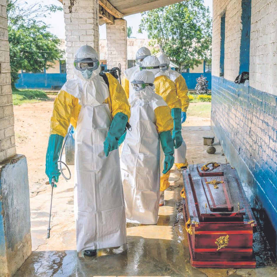 Health workers disinfect a coffin containing the body of a man presumed to have died of Ebola at a hospital in Mongbwalu, Democratic Republic of Congo, May 25, 2026. As the Ebola outbreak spreads in the Democratic Republic of Congo and Uganda, health workers are rushing to provide supportive care, hoping that some patients will recover on their own, while isolating the sick and tracing contacts of the infected. (Arlette Bashizi/The New York Times)
