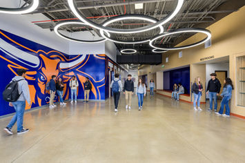 Students in modern school hallway, commercial architecture