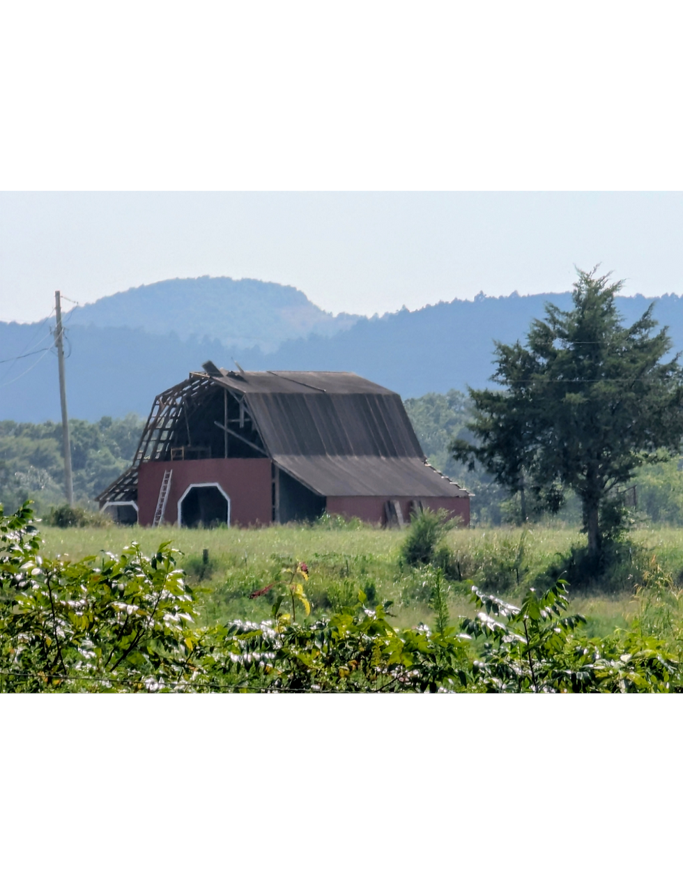 Original photograph of a distant red barn beneath the Ouachita Mountains.