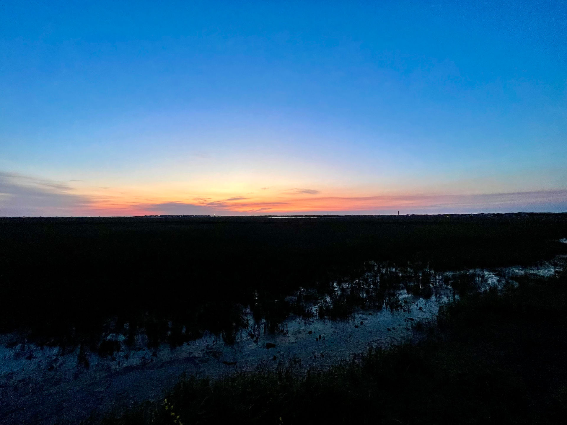 Colorful dawn sky over the salt marsh at Pitt Street Bridge
