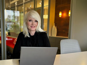 An image of Jennifer Torok sitting in Bennett Design's head office