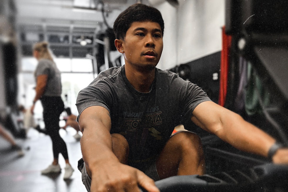CrossFit athlete resting after workout in Seattle gym, representing training fatigue and burnout