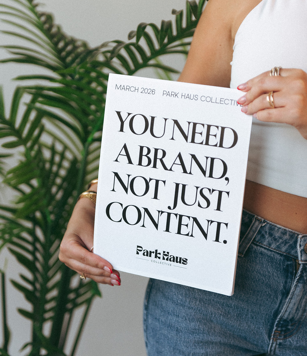 Person holding a sign that reads You Need a Brand Not Just Content representing Park Haus Collective brand strategy approach