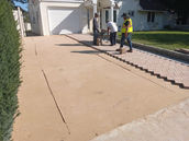 Crew laying a paver driveway border