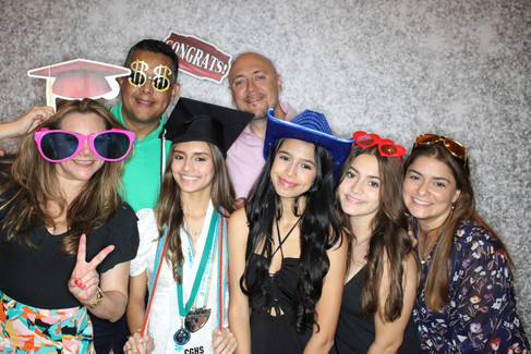 Friends and family gather together for fun poses at photo booth for Weston , Florida party