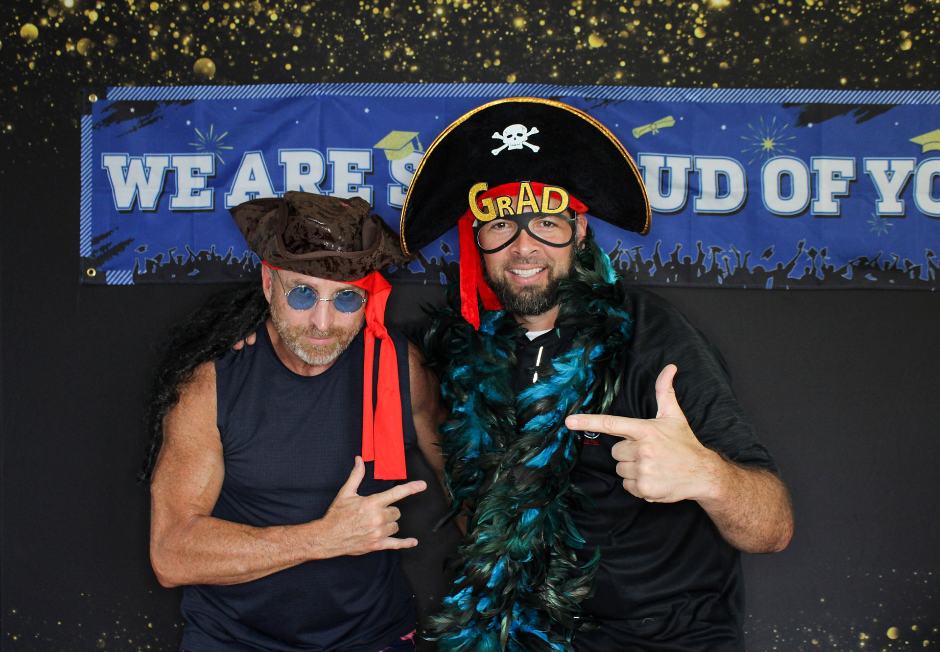 Guests smiling and posing in the photo booth at a graduation party