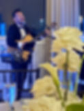 Harold Huertas performing live music with guitar at an elegant private event