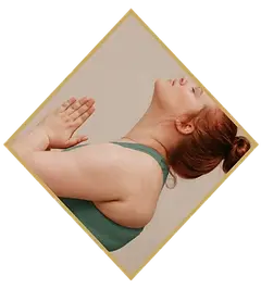 Woman meditating in soft light representing body-based healing and reconnection to the self