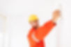 young-foreman-orange-work-clothes-yellow-hardhat-thoughtfully-using-putty-knife-work.jpg